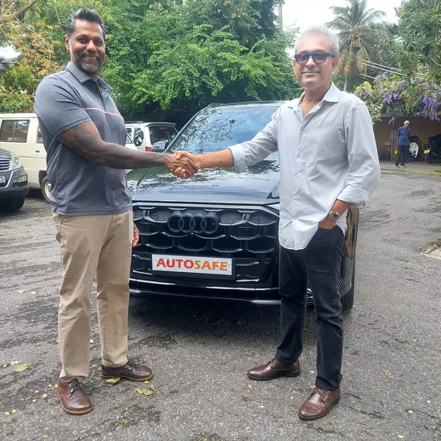 A handshake as an Autosafe customer takes delivery of their car