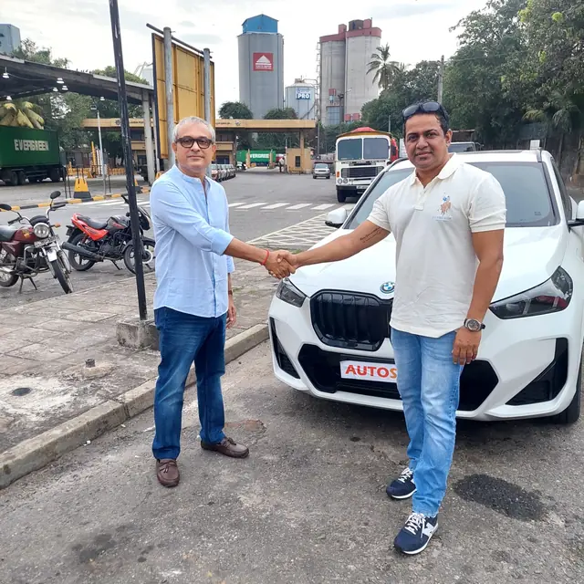 A handshake as an Autosafe customer takes delivery of their car