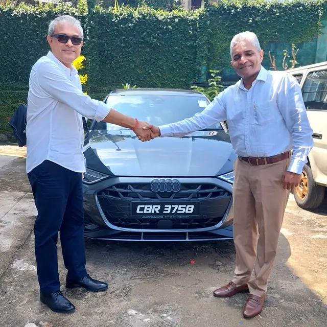 A handshake as an Autosafe customer takes delivery of their car