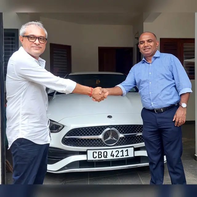 A handshake as an Autosafe customer takes delivery of their car