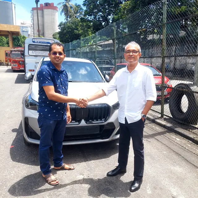 A handshake as an Autosafe customer takes delivery of their car