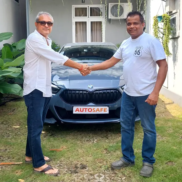 A handshake as an Autosafe customer takes delivery of their car