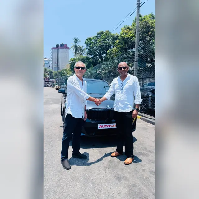 A handshake as an Autosafe customer takes delivery of their car